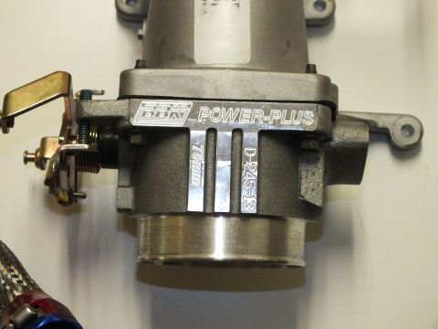 2003 Ford Crown Victoria - Closeup of BBK Power-Plus aluminum throttle body stamped 75mm and D-245-3, with throttle linkage at left