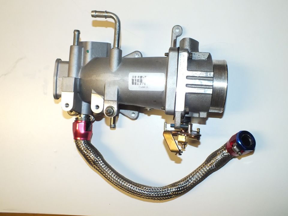 Aftermarket aluminum throttle body and intake assembly with braided fuel line and red and blue AN fittings
