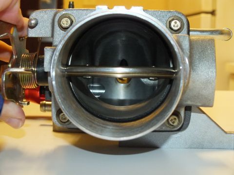 2003 Ford Crown Victoria - Aluminum throttle body bore with the blade cracked open, exposing the shaft, screws and gold return spring