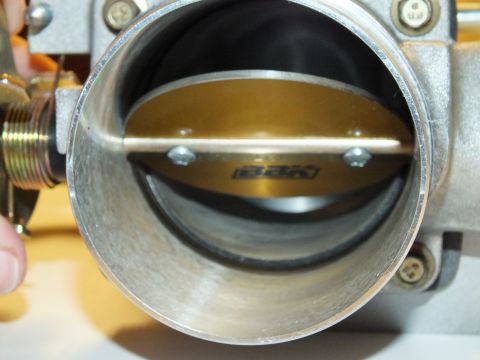 2003 Ford Crown Victoria - View into a throttle body showing the BBK-marked blade and shaft centered in the polished aluminum bore