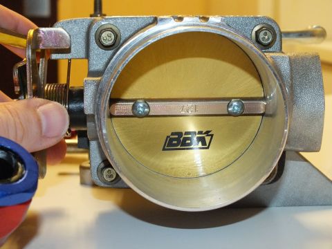 2003 Ford Crown Victoria - BBK-stamped throttle blade in an aluminum bore, a hand steadying the throttle linkage to the side