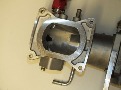 2003 Ford Crown Victoria - Square-flanged aluminum intake elbow showing the bore opening, a red AN fitting and a bent vacuum line