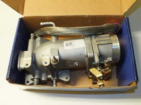 2003 Ford Crown Victoria - Cast aluminum intake plenum and throttle body with braided line resting inside an opened shipping box