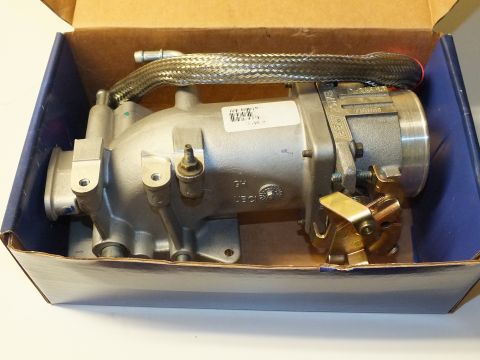 2003 Ford Crown Victoria - Intake casting and throttle body with gold-colored linkage packed in an opened blue-lined product box