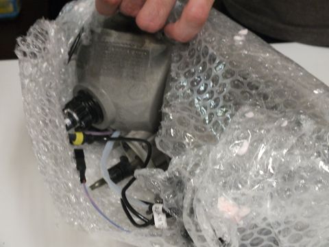 2003 Ford Crown Victoria - Aluminum-backed headlight unit with HID bulb and pigtail wiring partly unwrapped.