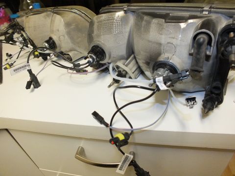 2003 Ford Crown Victoria - Aluminum headlight reflector housings laid out with HID bulb connectors and pigtail wiring.