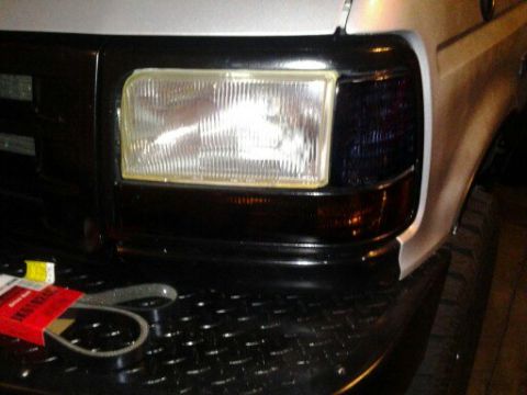 1996 Ford Bronco - A new serpentine belt sits on the diamond plate bumper of a 1992 Ford F-Series truck.