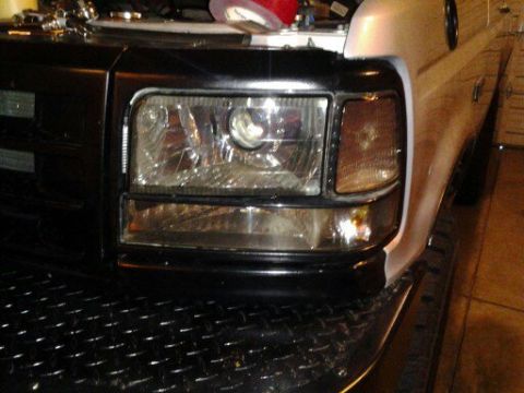1996 Ford Bronco - The front grille and headlight assembly of a Ford truck, likely from the early to mid-1990s.