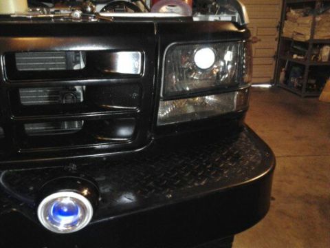 1996 Ford Bronco - Front view of a black Ford truck, likely from the early to mid-1990s, with a prominent grille and custom bumper.