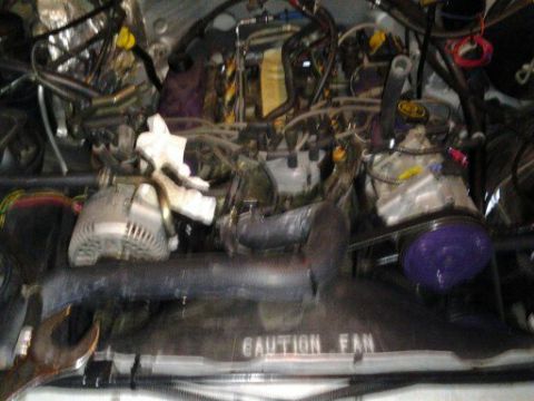 1996 Ford Bronco - Close-up view of a complex engine bay with many parts and wiring.