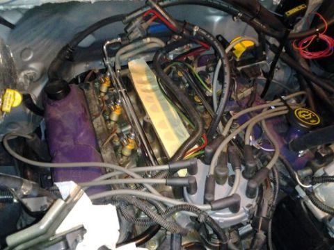 1996 Ford Bronco - Close-up view of a vehicle's engine bay, showing various components and wiring.