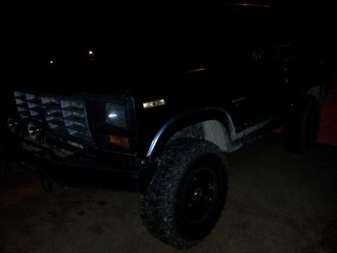1986 Ford Bronco - This 1986 Ford Bronco is captured from a front three-quarter angle at night.