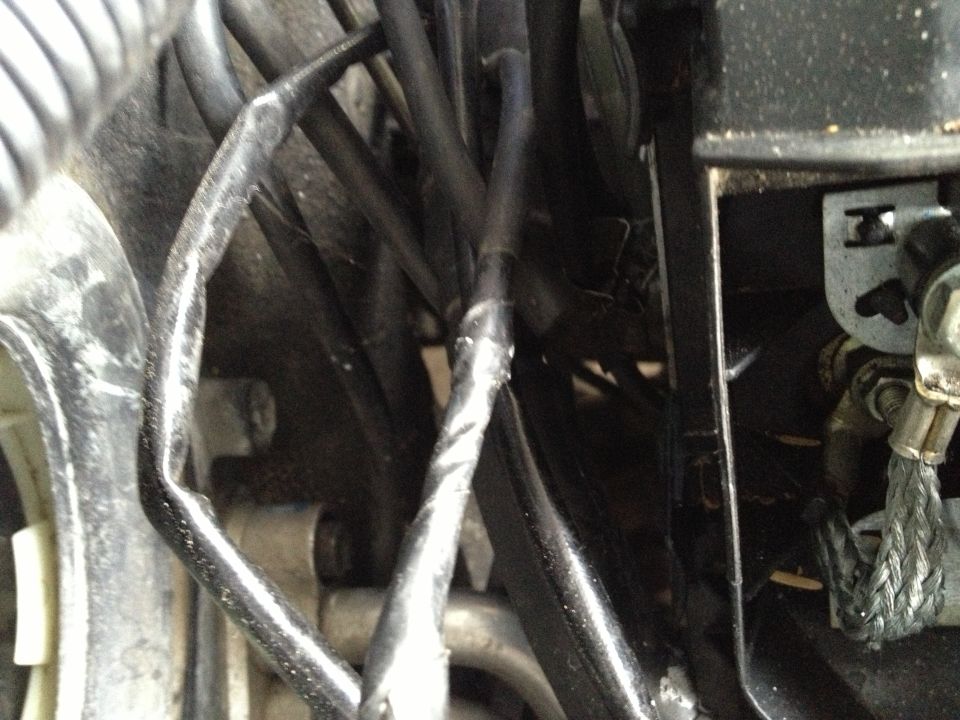 Close-up of engine wiring harness with black tape