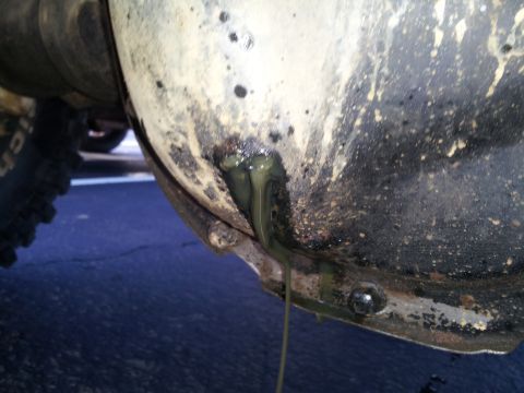 1986 Ford Bronco - Fluid is leaking from the differential housing, with a portion of a BFGoodrich tire visible in the frame.