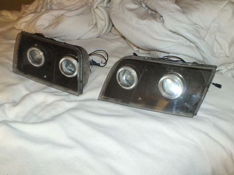 2003 Ford Crown Victoria - Custom retrofit headlamp pair with clear projector lenses and dark internal housings.