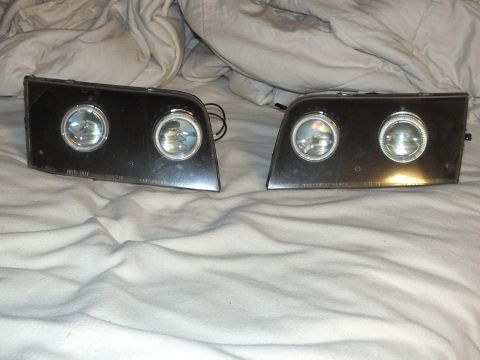2003 Ford Crown Victoria - Aftermarket headlamps featuring twin projectors, bright halo rings and lens part text.