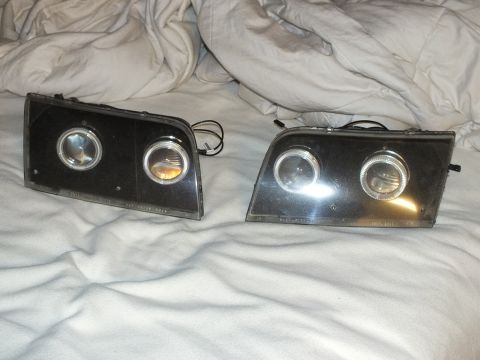 2003 Ford Crown Victoria - Custom retrofit headlamp pair, twin projector lenses and halo rings, etched lens text visible.