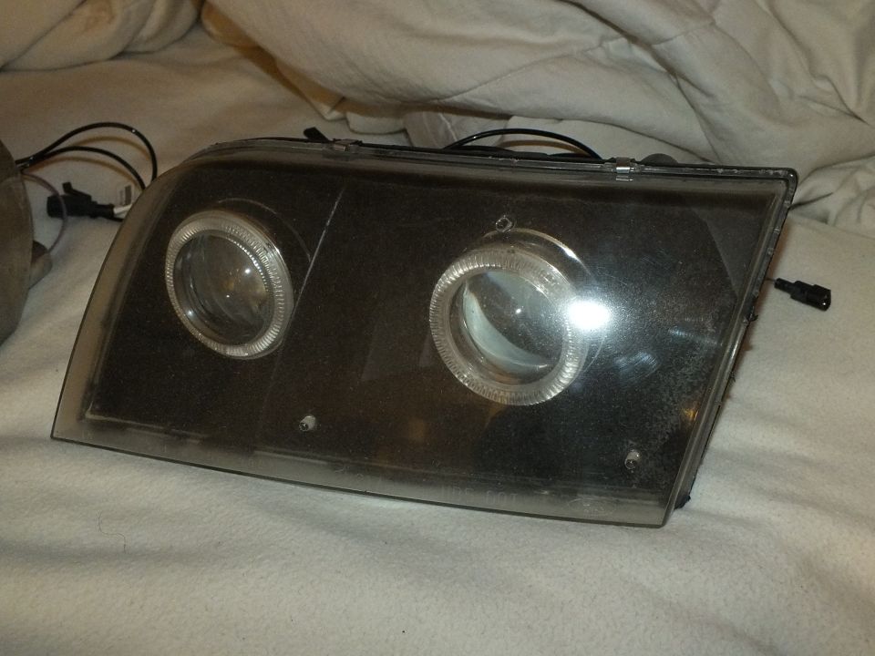Single custom dual-projector halo headlight unit close-up with reflective lens