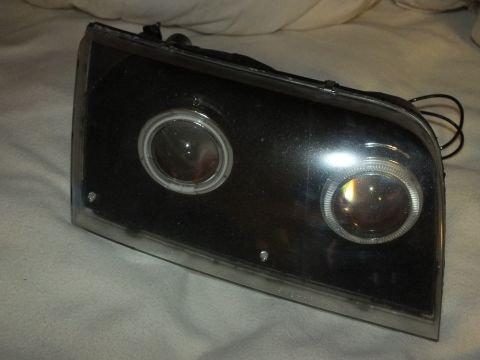 2003 Ford Crown Victoria - Single custom headlamp with twin projectors and amber-tinted projector bowls.