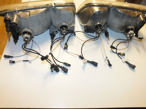 2003 Ford Crown Victoria - Backsides of two headlamps showing Ford ovals, bulb retainers and HID conversion wiring.