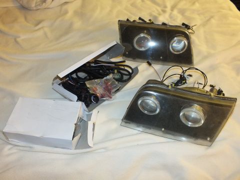 2003 Ford Crown Victoria - Custom headlamp pair displayed with a white box of HID harnesses and hardware.