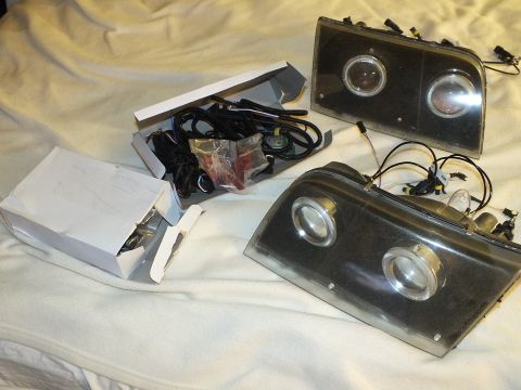 2003 Ford Crown Victoria - Custom headlamps with twin projectors shown alongside loose HID wiring and connectors.