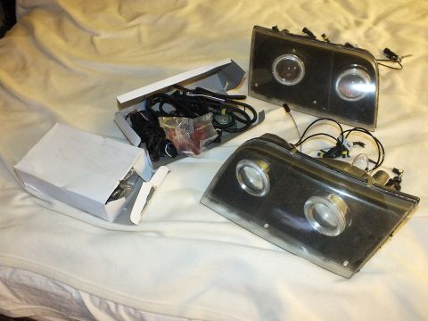 2003 Ford Crown Victoria - Custom headlamp pair with halo rings displayed beside HID bulbs and harness components.