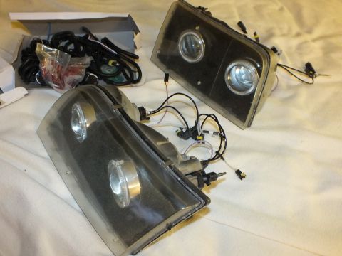 2003 Ford Crown Victoria - Two retrofitted headlight housings featuring projector lenses, angel-eye halo rings and loose ballast wiring kits.