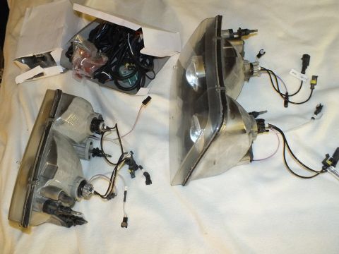 2003 Ford Crown Victoria - Retrofit headlight components including clear projector lenses, chrome reflectors and bundled connector wiring.