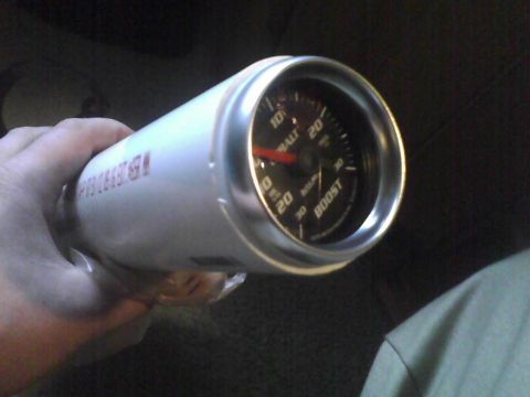 2003 Ford Crown Victoria - A white boost gauge with a silver bezel is held in a hand, showing readings up to 30 PSI.