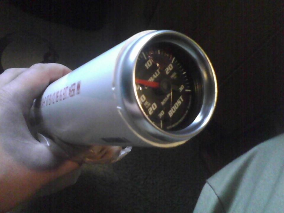 White boost gauge with red needle and silver bezel