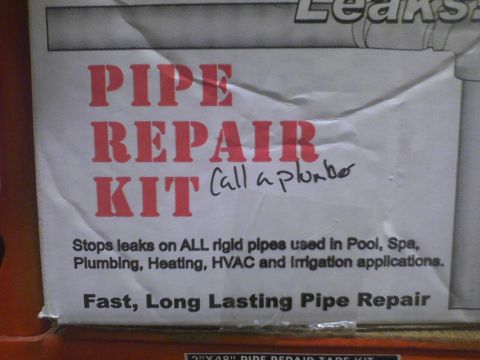 2003 Ford Crown Victoria - Packaging for a pipe repair kit, with handwritten note suggesting to call a plumber.