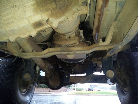 1986 Ford Bronco - A view of the underside of a vehicle, focusing on the transmission and drivetrain components.