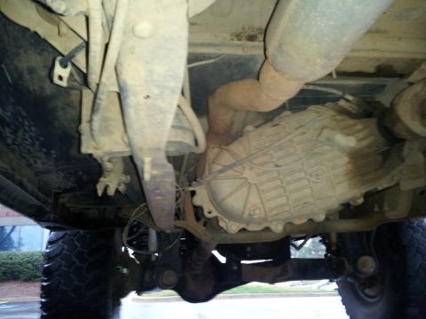 1986 Ford Bronco - This photo shows the underside of a 4x4 vehicle, focusing on the transfer case and exhaust system.