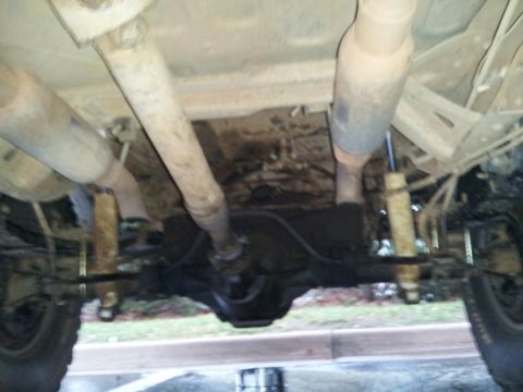 1986 Ford Bronco - Underside view of a 1986 Ford Bronco, showing the rear axle, driveshaft, and exhaust.
