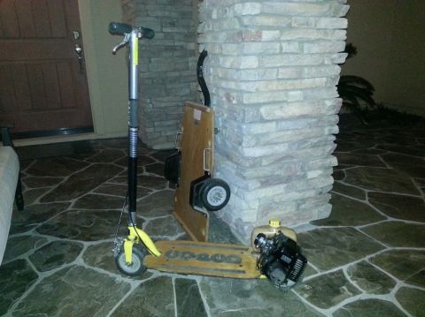 1978 Ford Bronco - A motorized scooter with a gas engine is parked on a stone floor next to a pillar.