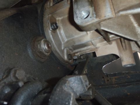 1978 Ford Bronco - Detail of a vehicle's transmission housing, showing bolts and surrounding mechanical parts.