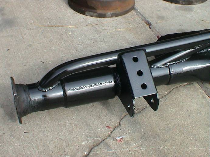 Close-up of welded black three-hole link bracket on an axle housing tube