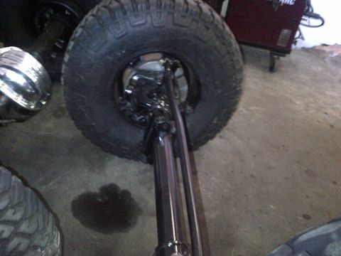1994 Ford Bronco - This image shows the suspension and tire of a vehicle, possibly undergoing modification or repair.
