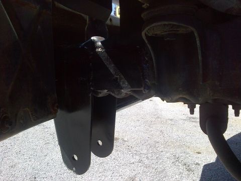 1994 Ford Bronco - Close-up view of vehicle suspension components, showing metal brackets and bolts.