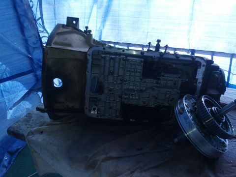 1995 Ford Bronco - Transmission assembly with torque converter removed, likely for repair or replacement.