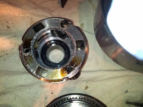 1995 Ford Bronco - Close-up of a damaged transmission component, showing wear and tear on the gears and casing.