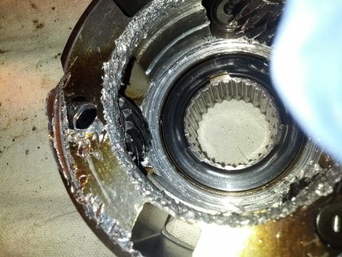 1995 Ford Bronco - Internal damage to a transmission part, showing broken splines and housing.