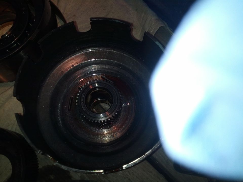 Close-up of a disassembled transmission component with gears visible inside
