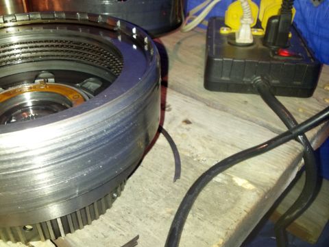 1995 Ford Bronco - A transmission clutch pack is shown with a power strip and electrical cords nearby.