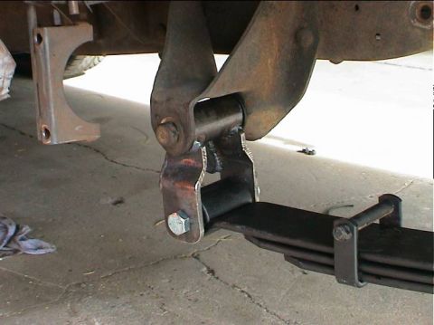 1979 Ford Bronco - Close-up view of vehicle leaf spring and suspension components, likely a rear axle modification.