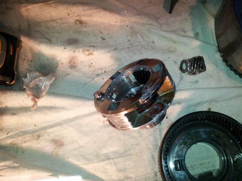 1995 Ford Bronco - Close-up of a damaged transmission part, possibly a planetary gear set, with other gears nearby.