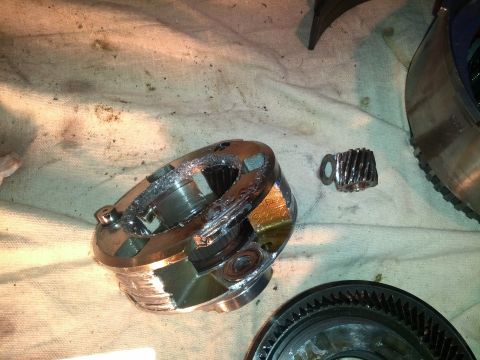 1995 Ford Bronco - The internal components of a transmission show significant damage and wear, with metal shavings scattered around.