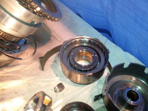 1995 Ford Bronco - Disassembled transmission components laid out on a cloth, showing gears and clutch packs.