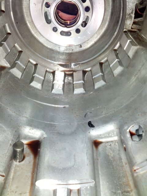 1995 Ford Bronco - Close-up view of the internal components of a transmission housing, showing wear and fluid.